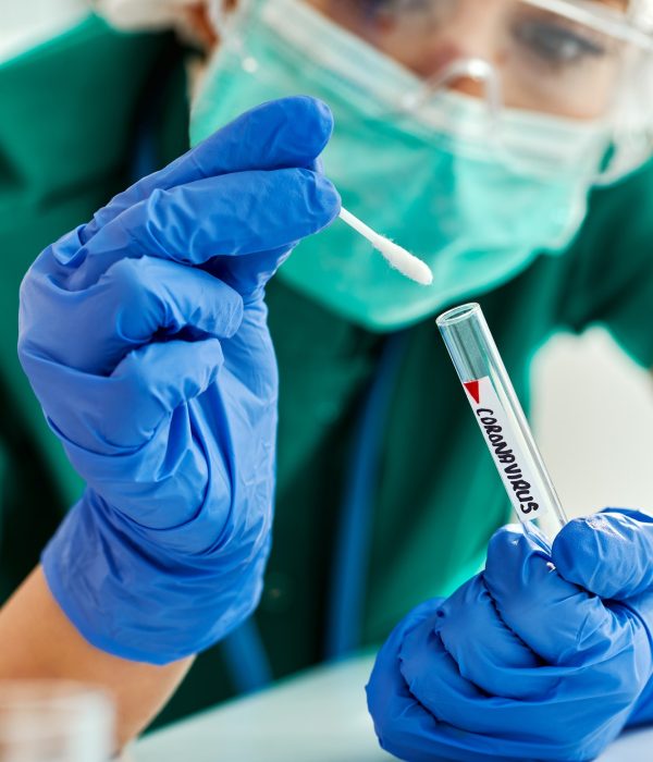 Close-up of healthcare expert examining coronavirus test sample.