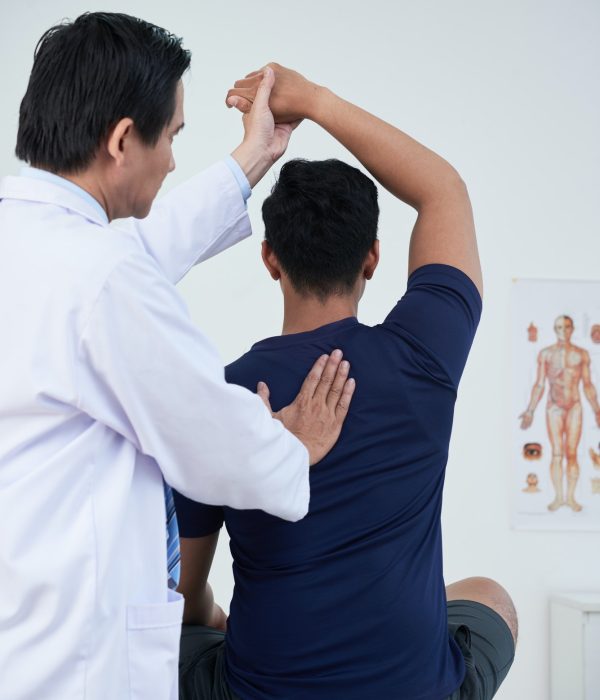 Professional Osteopath At Work With Patient