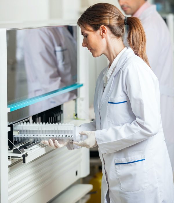 Researcher Loading Samples In Analyzer